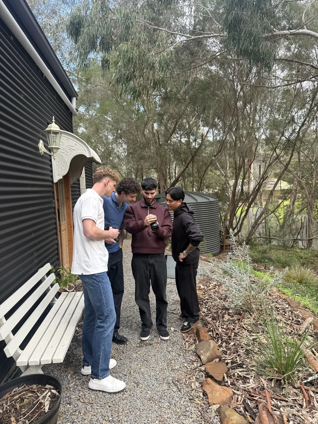 The team chatting outdoors between filming